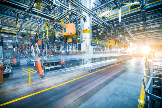 Robots welding in a car factory
